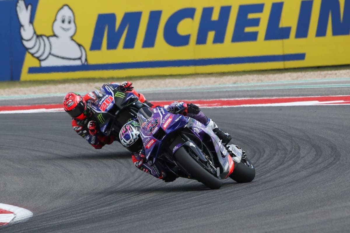 Motorcycle racer accelerating on track